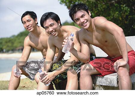 Three men sitting side by side, holding bottles of water, looking at camera View Large Photo Image Stock Image - Three men sitting side by side, holding bottles of water, looking at camera. Fotosearch
