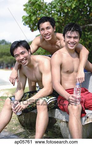 Stock Image - Three men without shirts, looking at camera. Fotosearch