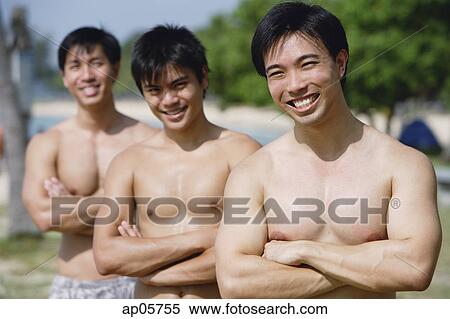 Stock Photography - Three shirtless men with arms crossed. Fotosearch