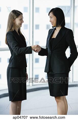Two businesswomen shaking hands View Large Photo Image Stock Photo - Two businesswomen shaking hands. Fotosearch