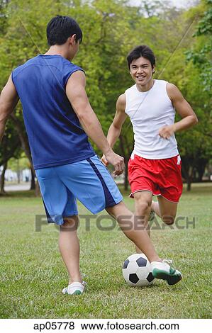 Two men in park, playing soccer View Large Photo Image Stock Photo - Two men in park, playing soccer. Fotosearch