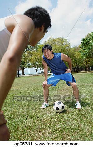Two men on field, taking a break from soccer game View Large Photo Image Stock Image - Two men on field, taking a break from soccer game. Fotosearch