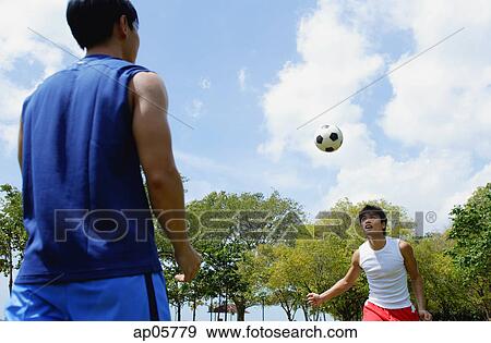 Two men playing soccer View Large Photo Image Stock Photo - Two men playing soccer. Fotosearch