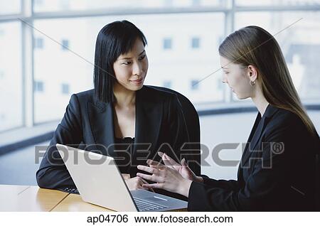 Two women in front of laptop View Large Photo Image Stock Photograph - Two women in front of laptop. Fotosearch