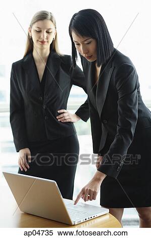 Stock Photography - Two women using laptop. Fotosearch