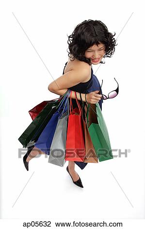 Woman carrying many shopping bags, high angle view View Large Photo Image Stock Image - Woman carrying many shopping bags, high angle view. Fotosearch