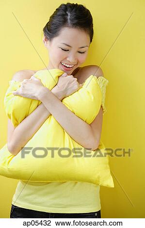 Woman embracing pillow View Large Photo Image Stock Image - Woman embracing pillow. Fotosearch