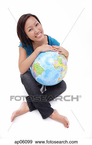 Woman holding globe, sitting cross-legged View Large Photo Image Stock Photo - Woman holding globe, sitting cross-legged. Fotosearch