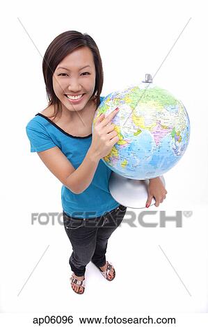 Woman holding globe, smiling at camera View Large Photo Image Stock Photograph - Woman holding globe, smiling at camera. Fotosearch
