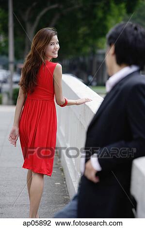Woman looking over shoulder at man behind her View Large Photo Image Stock Image - Woman looking over shoulder at man behind her. Fotosearch