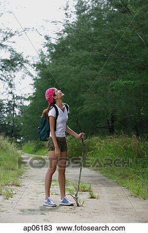 Woman on hiking trail, looking up View Large Photo Image Stock Image - Woman on hiking trail, looking up. Fotosearch