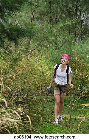 Picture - Woman on hiking trail. Fotosearch