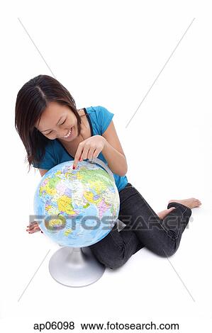Woman pointing at globe View Large Photo Image Stock Photo - Woman pointing at globe. Fotosearch
