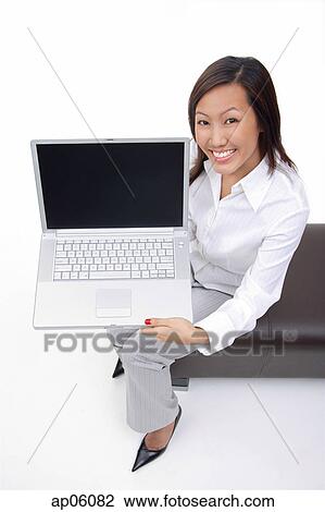 Woman sitting on bench, showing laptop to camera View Large Photo Image Stock Image - Woman sitting on bench, showing laptop to camera. Fotosearch