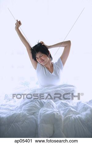 Woman stretching in bed View Large Photo Image Stock Image - Woman stretching in bed. Fotosearch