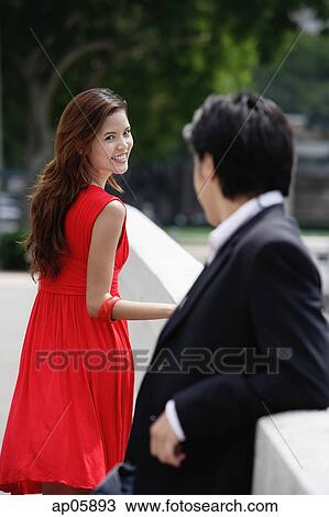 Stock Image - Woman turning to look at man. Fotosearch