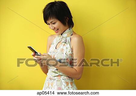 Woman using mobile phone, text messaging View Large Photo Image Picture - Woman using mobile phone, text messaging. Fotosearch