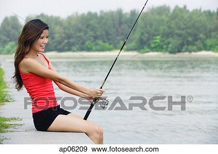 Woman with fishing rod View Large Photo Image Stock Photo - Woman with fishing rod. Fotosearch