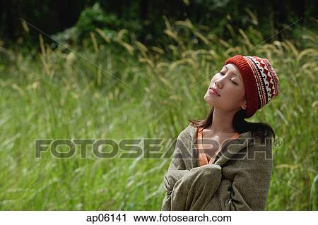 Woman wrapped in a blanket, eyes closed View Large Photo Image Stock Image - Woman wrapped in a blanket, eyes closed. Fotosearch