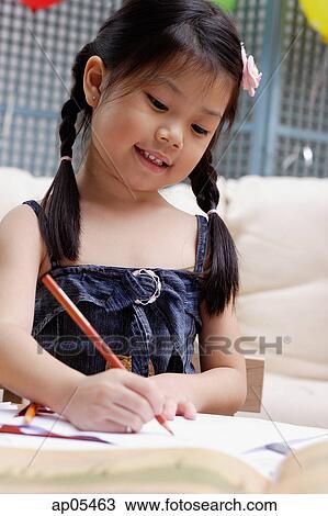 Stock Image - Young girl drawing. Fotosearch