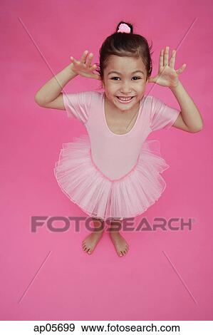 Stock Photo - Young girl in ballet outfit, hands on either side of face. Fotosearch
