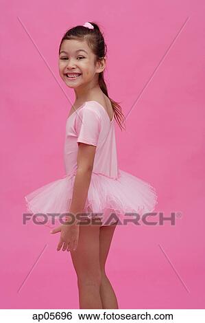 Young girl in ballet outfit, turning to smile at camera View Large Photo Image Stock Photograph - Young girl in ballet outfit, turning to smile at camera. Fotosearch