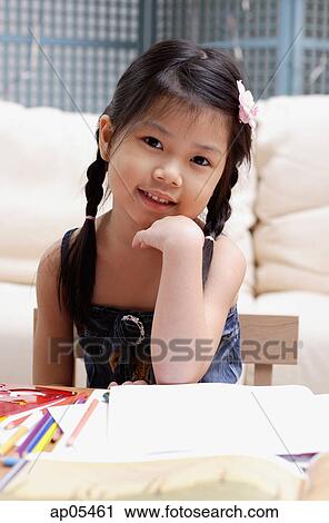 Young girl looking at camera, hand on chin View Large Photo Image Stock Image - Young girl looking at camera, hand on chin. Fotosearch