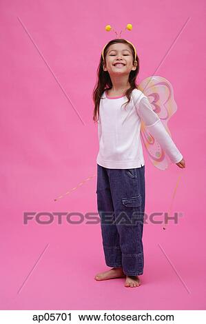 Stock Image - Young girl wearing fairy wings and deely bopper. Fotosearch