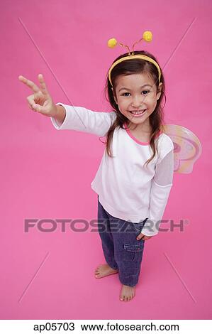 Young girl wearing fairy wings and deely bopper, making peace sign View Large Photo Image Stock Image - Young girl wearing fairy wings and deely bopper, making peace sign. Fotosearch