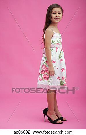 Young girl wearing high heel shoes 