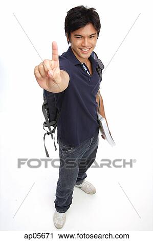 Young man carrying books and a backpack, making hand sign View Large Photo Image Stock Image - Young man carrying books and a backpack, making hand sign. Fotosearch