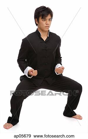 Stock Photo - Young man in martial arts position. Fotosearch