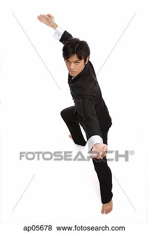 Young man practicing martial arts, looking at camera View Large Photo Image Stock Photo - Young man practicing martial arts, looking at camera. Fotosearch