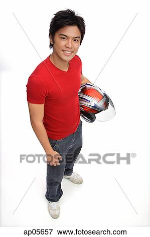 Young man with motorcycle helmet, smiling at camera View Large Photo Image Stock Photo - Young man with motorcycle helmet, smiling at camera. Fotosearch