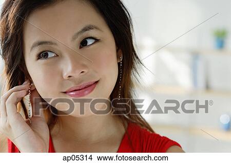 Young woman adjusting earring View Large Photo Image Picture - Young woman adjusting earring. Fotosearch