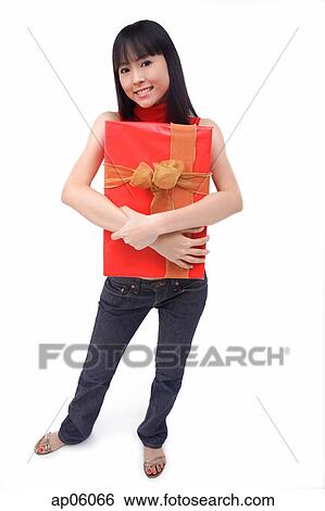 Young woman embracing big red gift box View Large Photo Image Stock Photograph - Young woman embracing big red gift box. Fotosearch