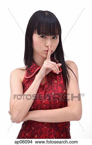 Picture - Young woman, finger on mouth. Fotosearch