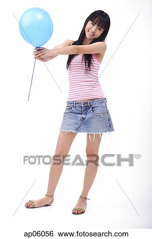 Young woman holding a blue balloon View Large Photo Image Stock Photograph - Young woman holding a blue balloon. Fotosearch