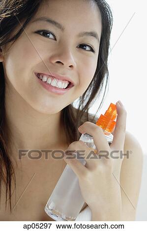 Young woman holding bottle, looking at camera View Large Photo Image Stock Photo - Young woman holding bottle, looking at camera. Fotosearch