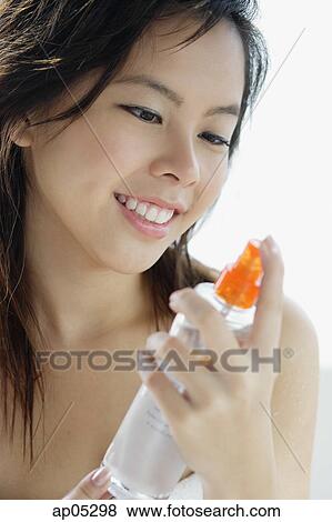 Young woman holding bottle View Large Photo Image Stock Photo - Young woman holding bottle. Fotosearch