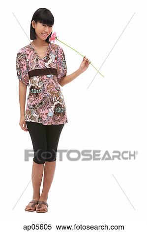 Young woman holding flower View Large Photo Image Stock Photography - Young woman holding flower. Fotosearch