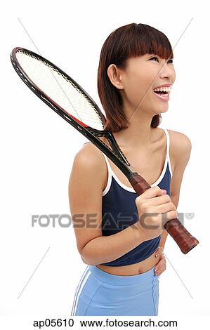 Young woman holding tennis racket over shoulder, smiling View Large Photo Image Stock Image - Young woman holding tennis racket over shoulder, smiling. Fotosearch