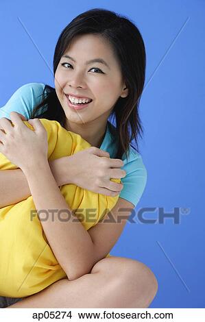 Young woman hugging pillow, portrait View Large Photo Image Picture - Young woman hugging pillow, portrait. Fotosearch