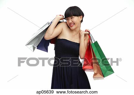 Young woman in black dress with shopping bags View Large Photo Image Stock Photo - Young woman in black dress with shopping bags. Fotosearch