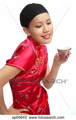 Young woman in cheongsam holding Chinese teacup View Large Photo Image Stock Image - Young woman in cheongsam holding Chinese teacup. Fotosearch