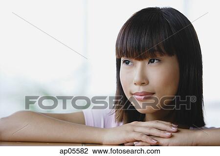 Young woman looking away, head shot View Large Photo Image Stock Image - Young woman looking away, head shot. Fotosearch