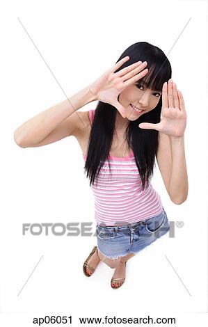 Young woman making hand frame, looking at camera View Large Photo Image Stock Image - Young woman making hand frame, looking at camera. Fotosearch