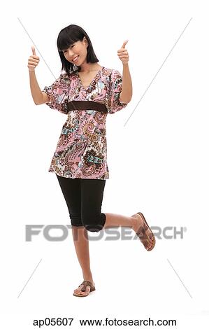 Young woman making thumbs up sign View Large Photo Image Stock Photo - Young woman making thumbs up sign. Fotosearch