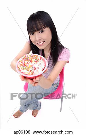 Young woman offering bowl of ice cream View Large Photo Image Stock Photo - Young woman offering bowl of ice cream. Fotosearch