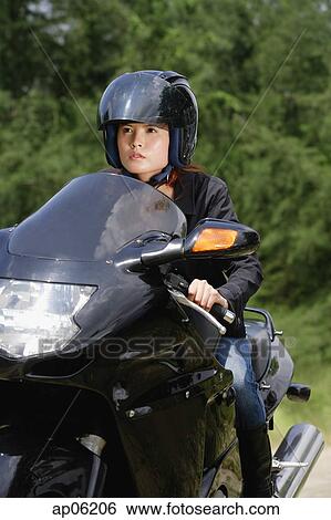 Young woman riding motorbike View Large Photo Image Stock Photograph - Young woman riding motorbike. Fotosearch